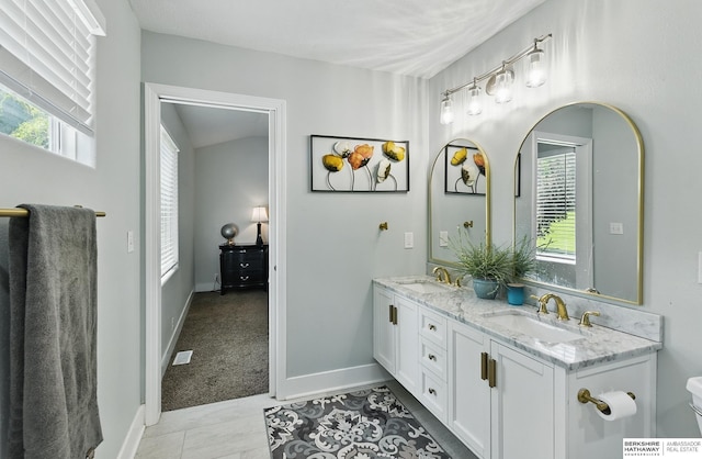 5135 N 159th Cir, Omaha, NE 68116 - bathroom featuring double vanity, baseboards, and toilet