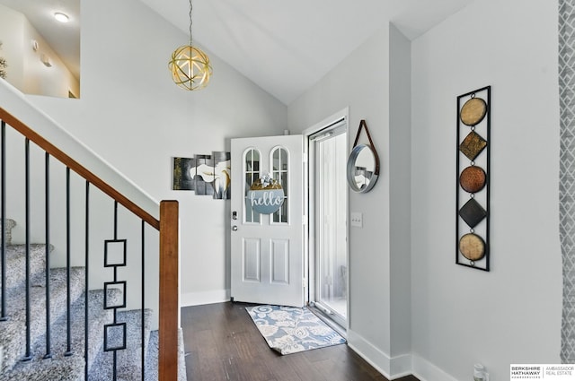 5135 N 159th Cir, Omaha, NE 68116 - foyer entrance featuring dark wood finished floors, a chandelier, stairway, high vaulted ceiling, and baseboards