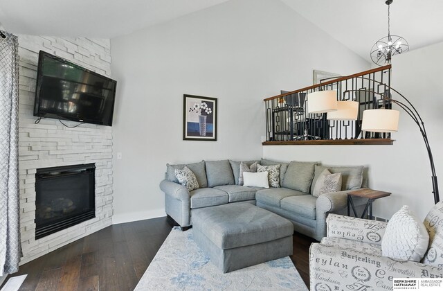 5135 N 159th Cir, Omaha, NE 68116 - living area with wood-type flooring, a stone fireplace, high vaulted ceiling, and a chandelier