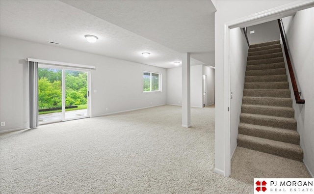 6713 N 148th St, Omaha, NE 68116 - basement with carpet flooring, stairway, and a textured ceiling