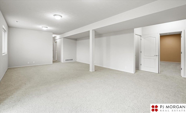 6713 N 148th St, Omaha, NE 68116 - finished below grade area featuring light colored carpet and baseboards