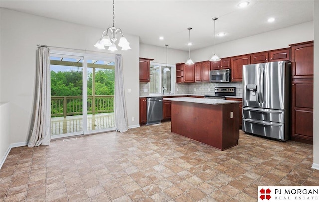 6713 N 148th St, Omaha, NE 68116 - kitchen with appliances with stainless steel finishes, light countertops, stone finish floors, a center island, and tasteful backsplash