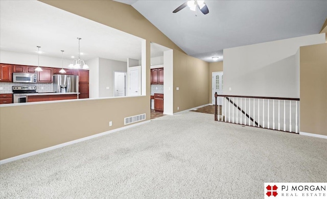 6713 N 148th St, Omaha, NE 68116 - carpeted spare room with a ceiling fan and vaulted ceiling