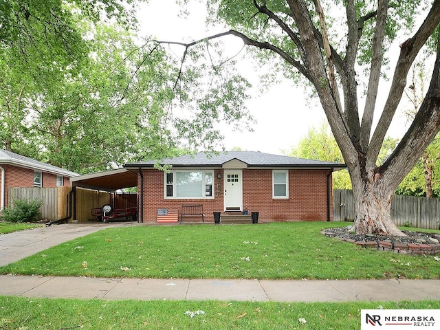 2000 N 53rd St, Lincoln, NE 68504 - ranch-style house featuring brick siding, a carport, driveway, and entry steps