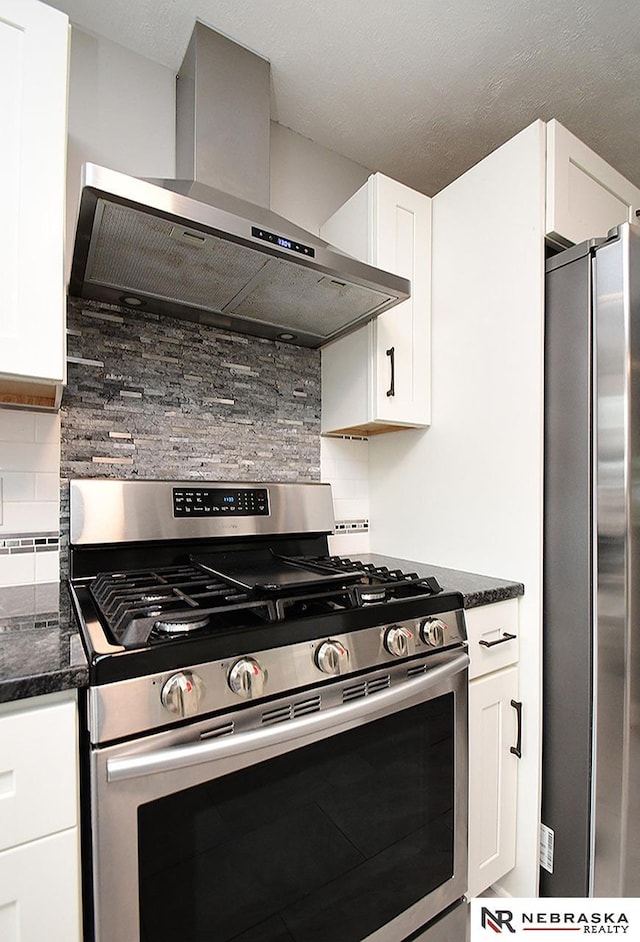 2000 N 53rd St, Lincoln, NE 68504 - kitchen featuring appliances with stainless steel finishes, wall chimney exhaust hood, backsplash, and white cabinetry