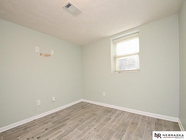 2000 N 53rd St, Lincoln, NE 68504 - spare room featuring wood finished floors and a textured ceiling