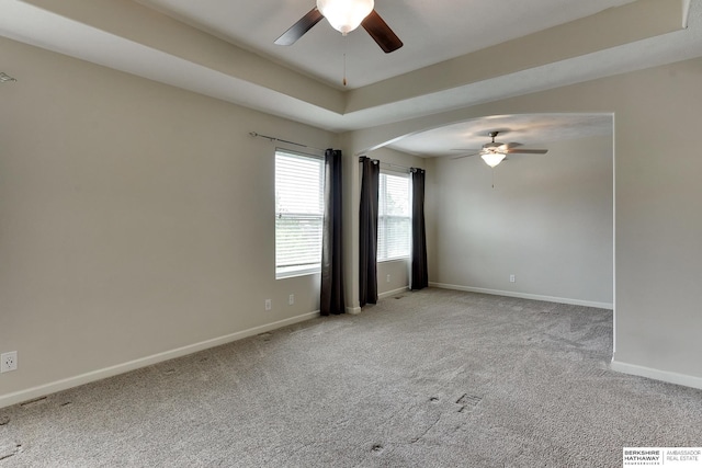 18337 Polk St, Omaha, NE 68135 - empty room featuring ceiling fan, carpet, baseboards, and arched walkways