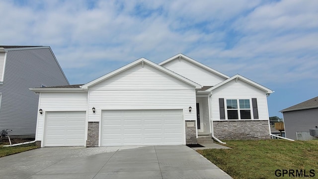 8515 S 184th Ave, Gretna, NE 68136 - view of front of property with stone siding, driveway, a garage, and a front yard