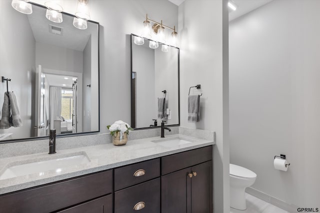 636 N 46th St, Omaha, NE 68132 - full bath with toilet, double vanity, and baseboards