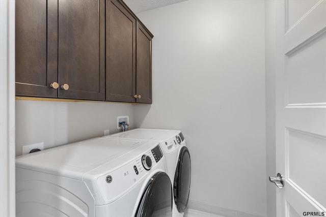 636 N 46th St, Omaha, NE 68132 - washroom featuring cabinet space, washer and clothes dryer, and baseboards