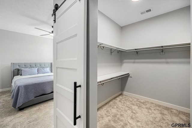 636 N 46th St, Omaha, NE 68132 - spacious closet with light colored carpet, a ceiling fan, and a barn door