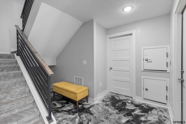 636 N 46th St, Omaha, NE 68132 - foyer entrance with a textured ceiling, baseboards, stairway, and vaulted ceiling