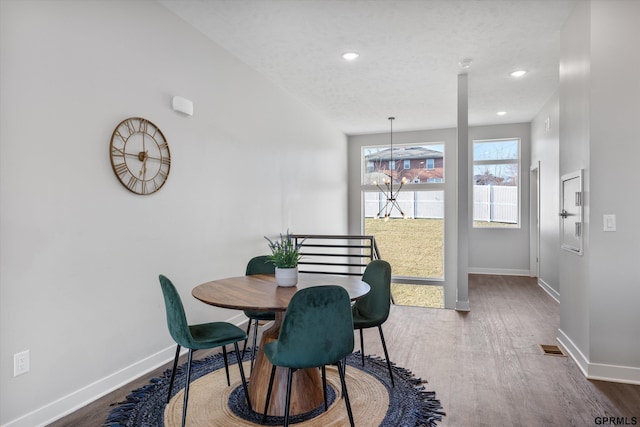 636 N 46th St, Omaha, NE 68132 - dining room with baseboards, dark wood-style floors, recessed lighting, and a chandelier