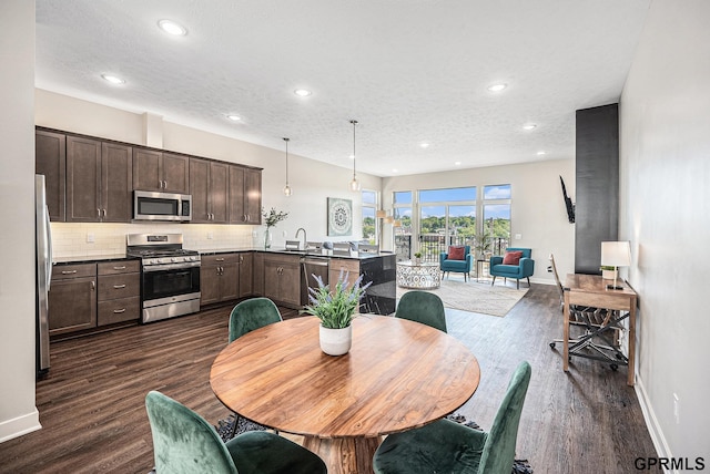 636 N 46th St, Omaha, NE 68132 - dining area with dark wood-type flooring, recessed lighting, baseboards, and a textured ceiling