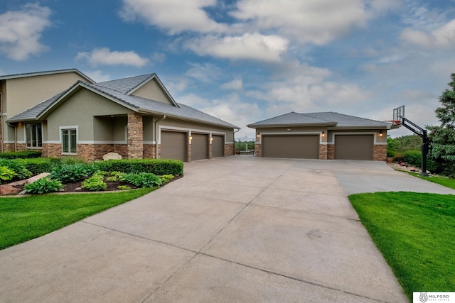 4725 S 184th Plz, Omaha, NE 68135 - view of front facade with stone siding, concrete driveway, stucco siding, and a garage