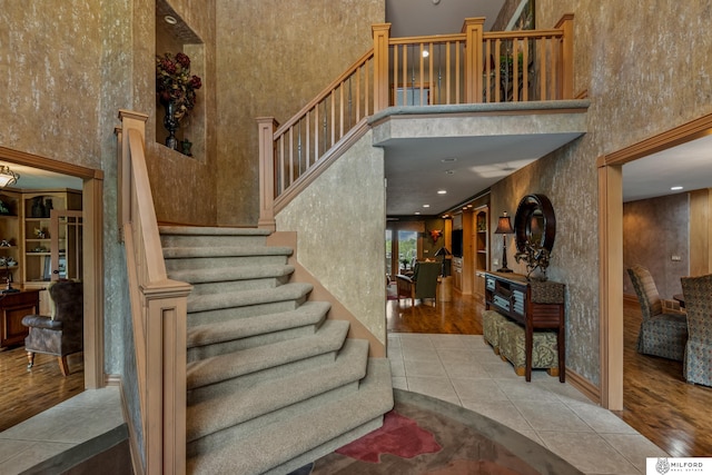 4725 S 184th Plz, Omaha, NE 68135 - staircase featuring a high ceiling and tile patterned flooring