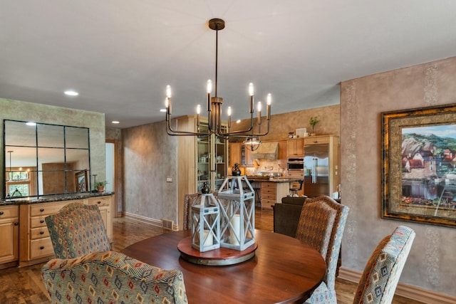 4725 S 184th Plz, Omaha, NE 68135 - dining room featuring dark wood-type flooring, a chandelier, and baseboards