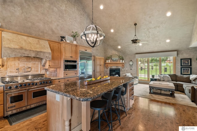 4725 S 184th Plz, Omaha, NE 68135 - kitchen featuring high end appliances, open floor plan, lofted ceiling, light wood-style flooring, and a center island