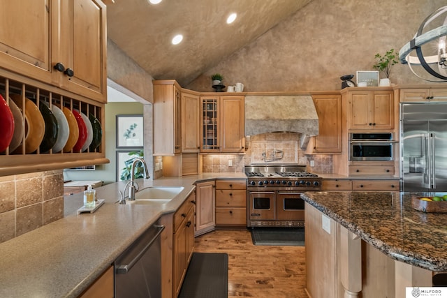 4725 S 184th Plz, Omaha, NE 68135 - kitchen with high quality appliances, a sink, premium range hood, light wood finished floors, and tasteful backsplash