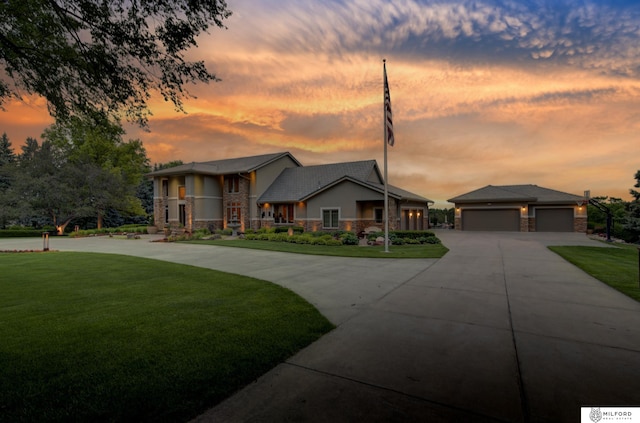 4725 S 184th Plz, Omaha, NE 68135 - modern home featuring curved driveway, a yard, stone siding, and a garage