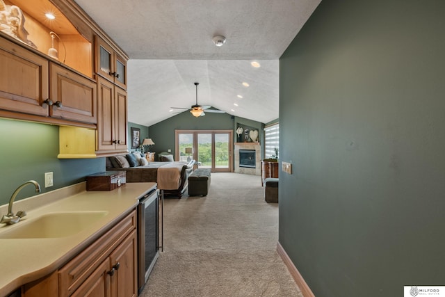 4725 S 184th Plz, Omaha, NE 68135 - kitchen featuring a sink, light colored carpet, vaulted ceiling, a ceiling fan, and beverage cooler