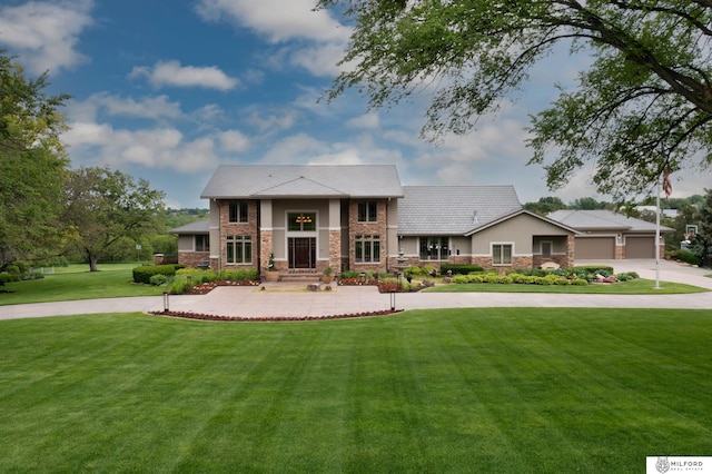 4725 S 184th Plz, Omaha, NE 68135 - view of front of home featuring curved driveway, stone siding, a front yard, and stucco siding