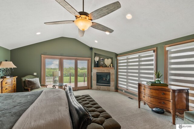 4725 S 184th Plz, Omaha, NE 68135 - carpeted bedroom featuring access to outside, vaulted ceiling, multiple windows, a tile fireplace, and ceiling fan