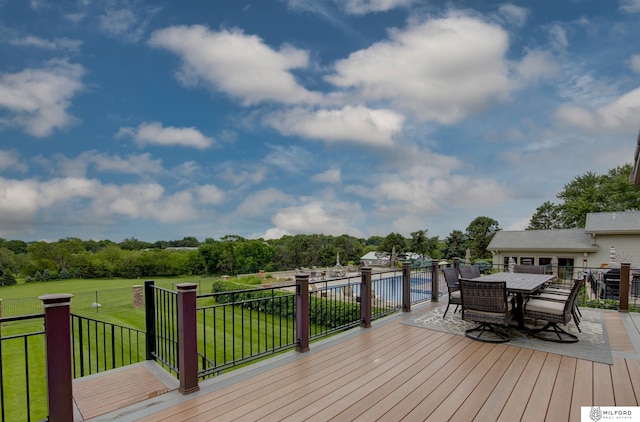 4725 S 184th Plz, Omaha, NE 68135 - wooden deck with a yard, outdoor dining area, and view of wooded area