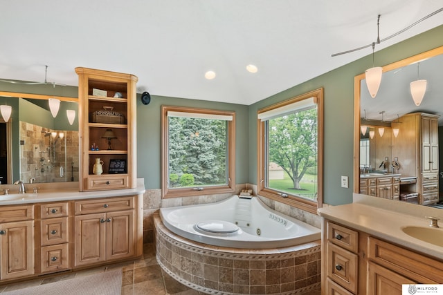 4725 S 184th Plz, Omaha, NE 68135 - full bathroom featuring healthy amount of natural light, two vanities, a jetted tub, and recessed lighting