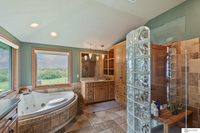 4725 S 184th Plz, Omaha, NE 68135 - bathroom with vanity, a tub with jets, vaulted ceiling, stone tile floors, and recessed lighting