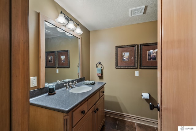 4725 S 184th Plz, Omaha, NE 68135 - bathroom with vanity, tile patterned flooring, a textured ceiling, and baseboards