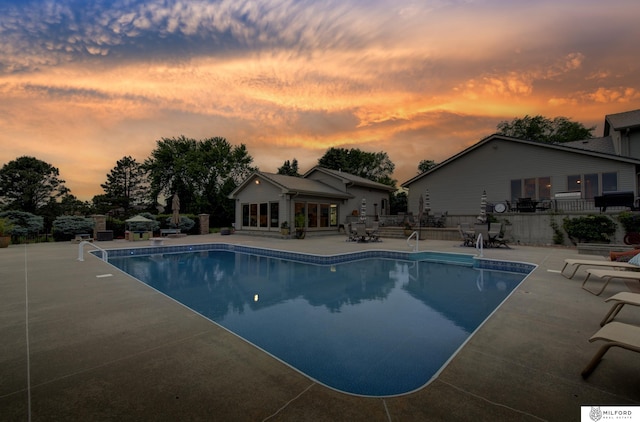 4725 S 184th Plz, Omaha, NE 68135 - pool at dusk featuring a storage structure, a patio area, an outdoor structure, and an outdoor pool