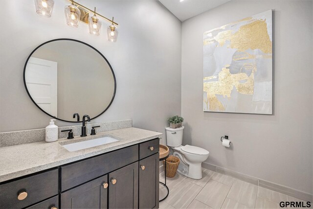 630 N 46th St, Omaha, NE 68132 - bathroom featuring vanity, toilet, and baseboards