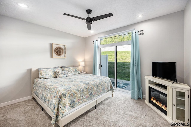 630 N 46th St, Omaha, NE 68132 - bedroom with access to exterior, carpet floors, baseboards, ceiling fan, and a glass covered fireplace