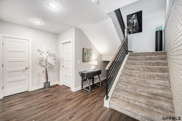 630 N 46th St, Omaha, NE 68132 - stairs featuring wood finished floors, a textured ceiling, baseboards, and recessed lighting