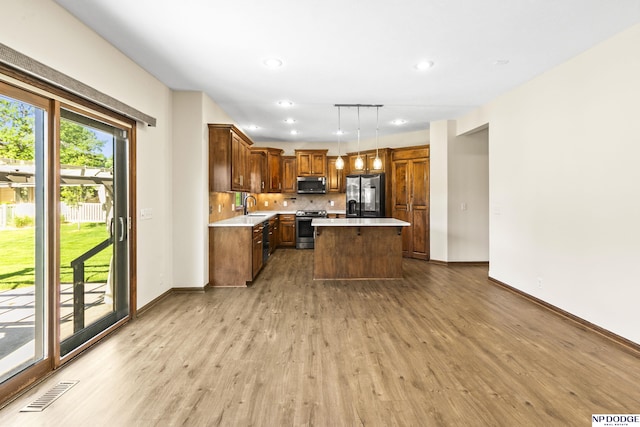 19677 Lamont St, Omaha, NE 68130 - kitchen featuring appliances with stainless steel finishes, light wood-style flooring, light countertops, a sink, and recessed lighting