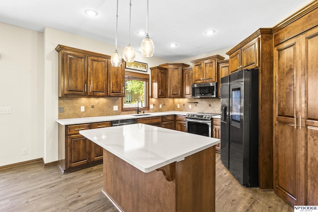 19677 Lamont St, Omaha, NE 68130 - kitchen featuring stainless steel appliances, a sink, light wood-type flooring, backsplash, and recessed lighting