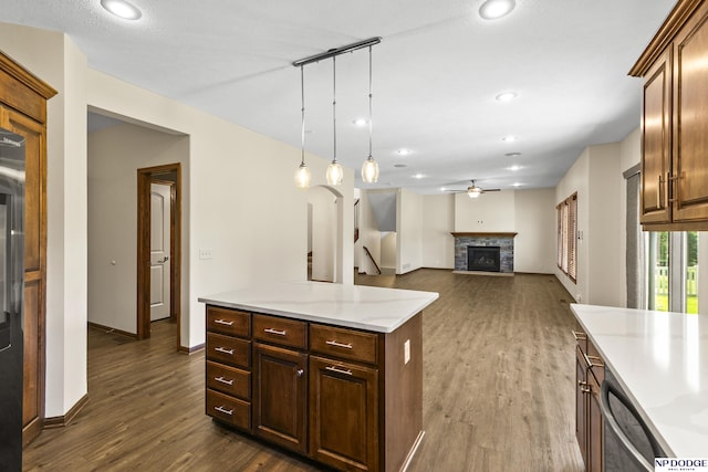 19677 Lamont St, Omaha, NE 68130 - kitchen featuring a ceiling fan, dark wood finished floors, a fireplace, stainless steel dishwasher, and baseboards