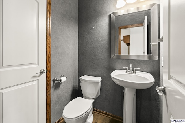 19677 Lamont St, Omaha, NE 68130 - half bathroom with toilet, wood finished floors, a textured wall, and baseboards
