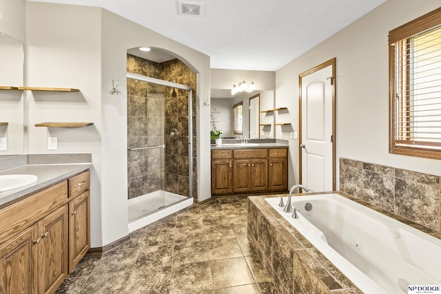 19677 Lamont St, Omaha, NE 68130 - full bathroom featuring a stall shower, two vanities, a jetted tub, and plenty of natural light