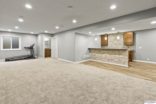 19677 Lamont St, Omaha, NE 68130 - unfurnished living room with baseboards, recessed lighting, light wood-type flooring, and light colored carpet