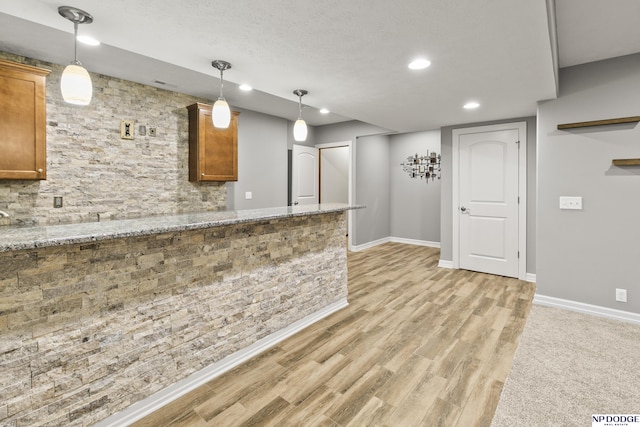 19677 Lamont St, Omaha, NE 68130 - kitchen featuring brown cabinets, baseboards, pendant lighting, and recessed lighting