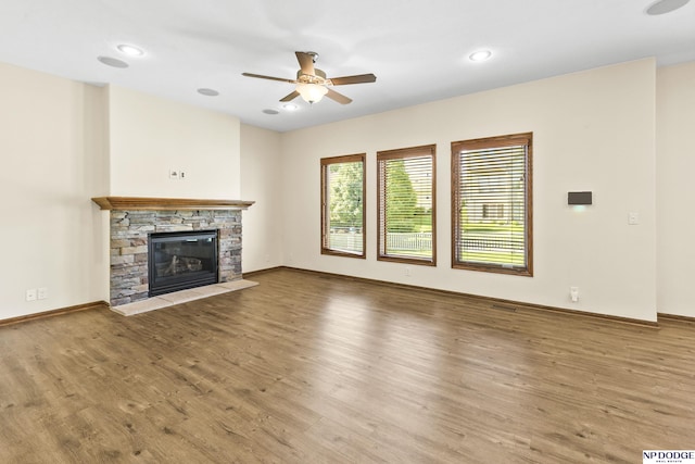 19677 Lamont St, Omaha, NE 68130 - unfurnished living room with ceiling fan, wood finished floors, a fireplace, baseboards, and recessed lighting