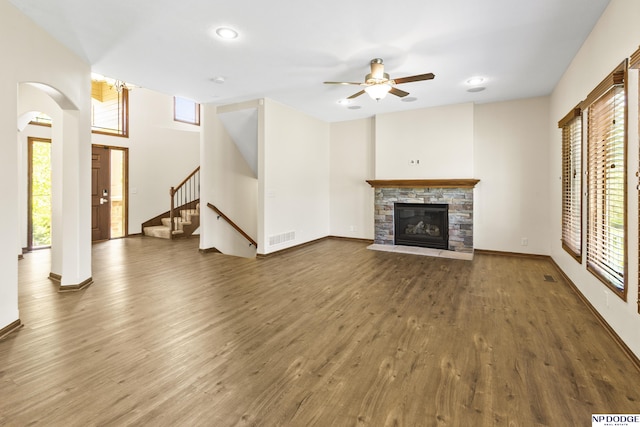 19677 Lamont St, Omaha, NE 68130 - unfurnished living room featuring wood finished floors, a stone fireplace, a ceiling fan, stairway, and recessed lighting