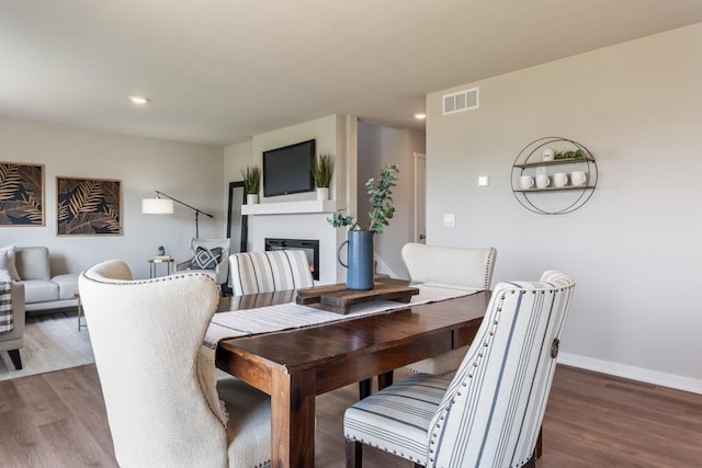 8514 S 184th Ave, Gretna, NE 68136 - dining space featuring wood finished floors, a glass covered fireplace, recessed lighting, and baseboards