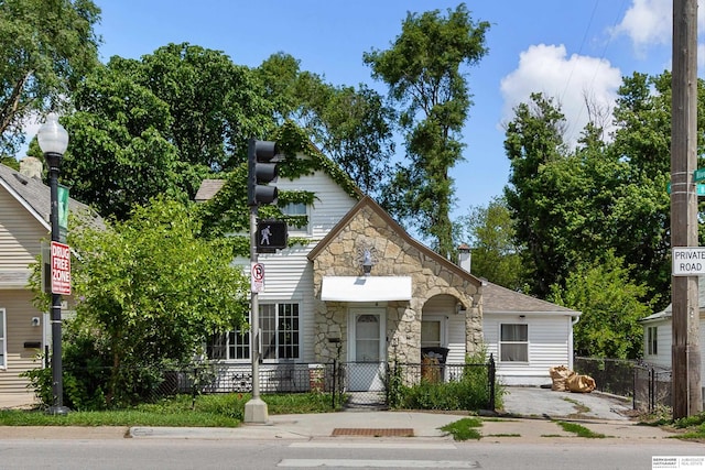 712 Bancroft St, Omaha, NE 68108 - view of front facade with stone siding, a fenced front yard, and a gate
