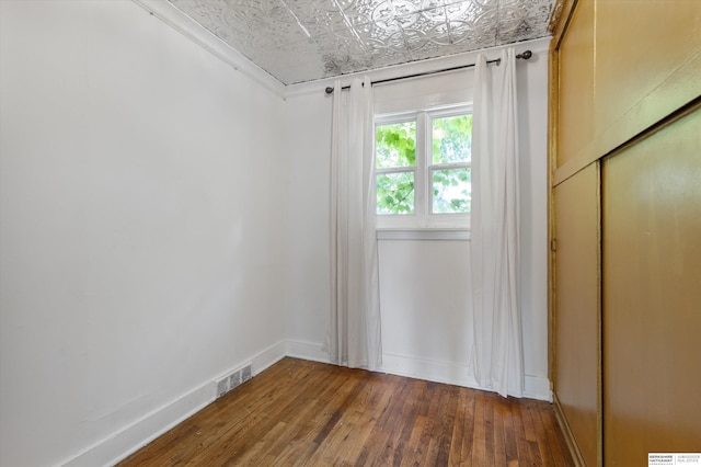 712 Bancroft St, Omaha, NE 68108 - unfurnished bedroom with hardwood / wood-style flooring, an ornate ceiling, baseboards, a closet, and ornamental molding