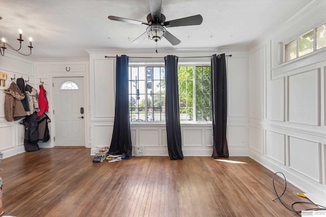 712 Bancroft St, Omaha, NE 68108 - entryway with a decorative wall, a chandelier, a ceiling fan, wood finished floors, and crown molding