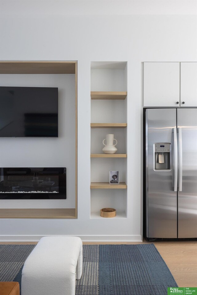 5301 Elmwood Plz, Omaha, NE 68106 - detailed view of stainless steel refrigerator with ice dispenser, built in features, and wood finished floors