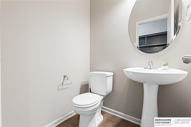 20904 Camden Ave, Omaha, NE 68022 - half bathroom featuring wood finished floors, toilet, baseboards, and a sink